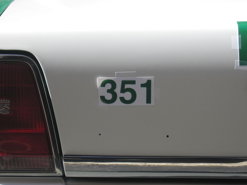 Green number 351 decal on the white rear quarter panel of a sedan