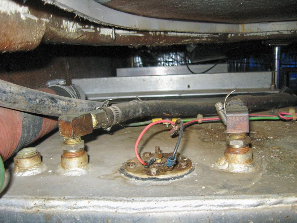 Sender unit with colored wiring between brass fittings on a metal tank