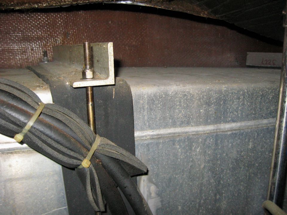 Threaded J-bolt clamp securing a tank under a deck with bundled wiring
