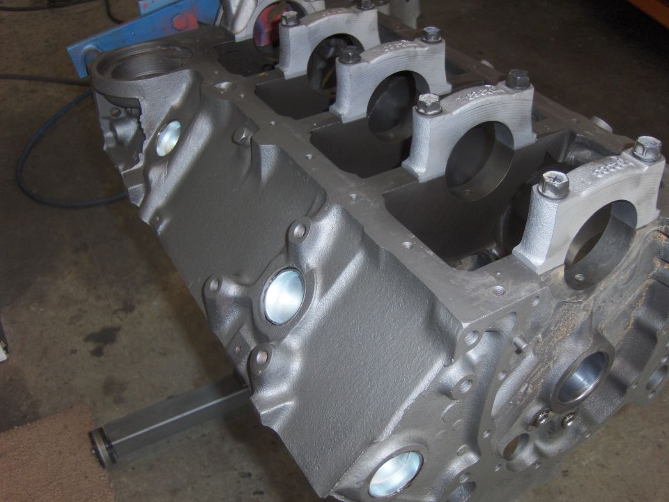 Gray cast iron engine block with main bearing caps installed.