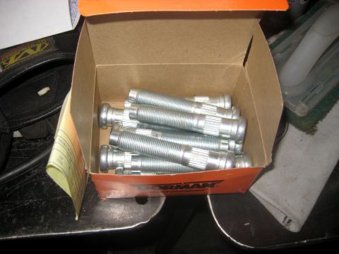 1996 Ford Bronco - A box of Dorman lug bolts is shown, with the Dorman logo visible on the orange packaging. The bolts are silver and have a threaded shaft wi…