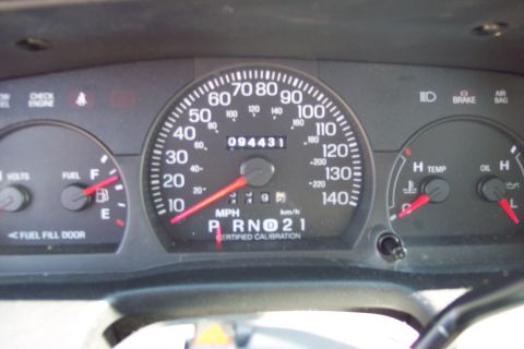 2001 Ford Crown Victoria - The image shows a close-up of a car's dashboard, focusing on the speedometer, odometer, fuel gauge, and temperature gauge. The odometer rea…