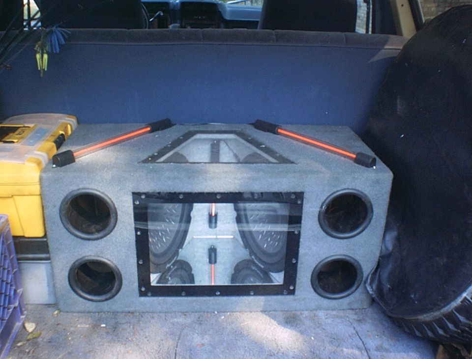 2 Pioneer 12" subs in a Banpass box, powerd by a elcheepo amp that was tweaked to 532 watts rms. I have it set at 3/4 gain.
