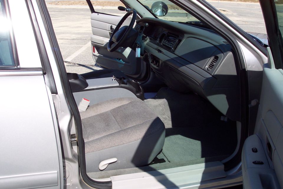 Interior of a silver 2001 Ford Crown Victoria, driver's side view.