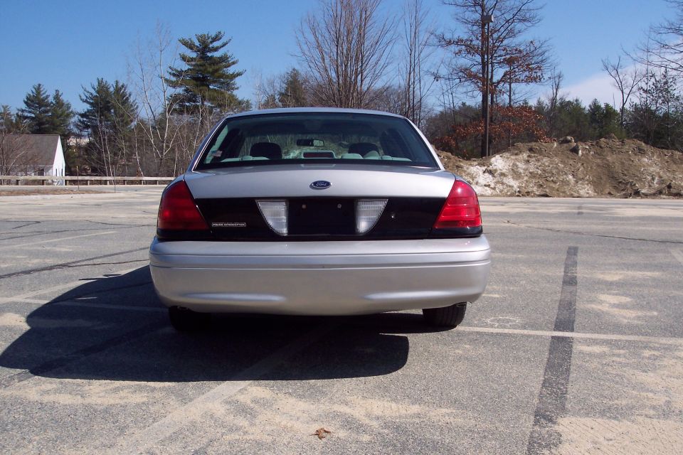 Rear view of a silver 2001 Ford Crown Victoria sedan.