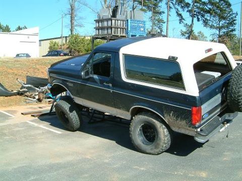 1993 Ford Bronco - This 1993 Ford Bronco features a lifted suspension and large off-road tires, suggesting modifications for off-road use.
