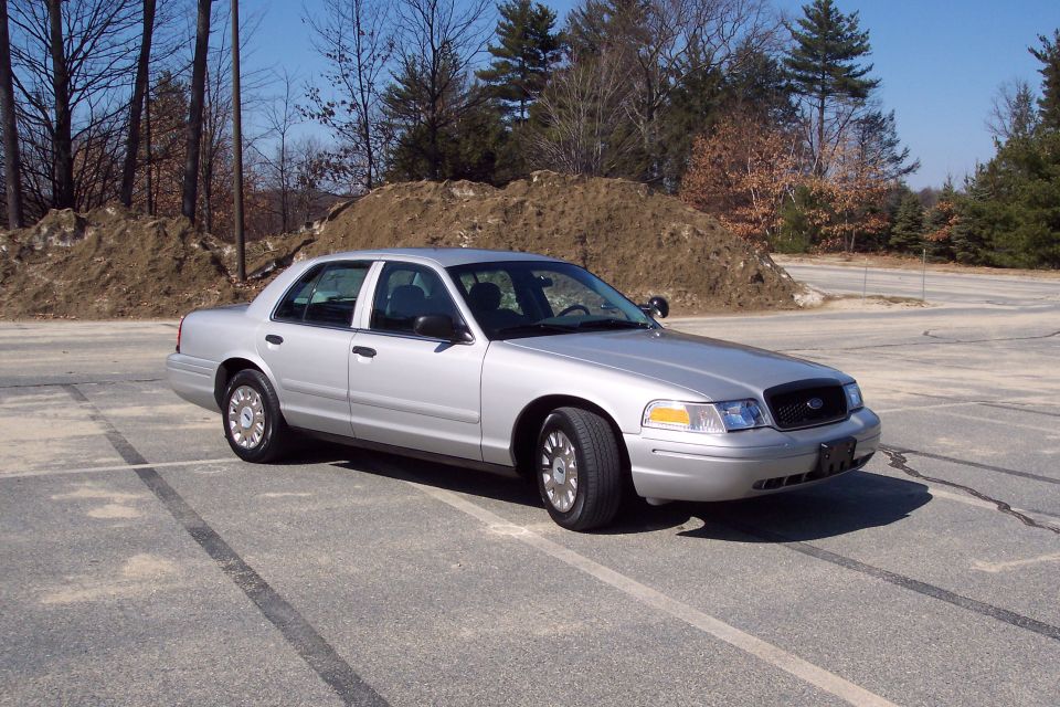 Silver 2001 Ford Crown Victoria sedan parked in an outdoor lot.