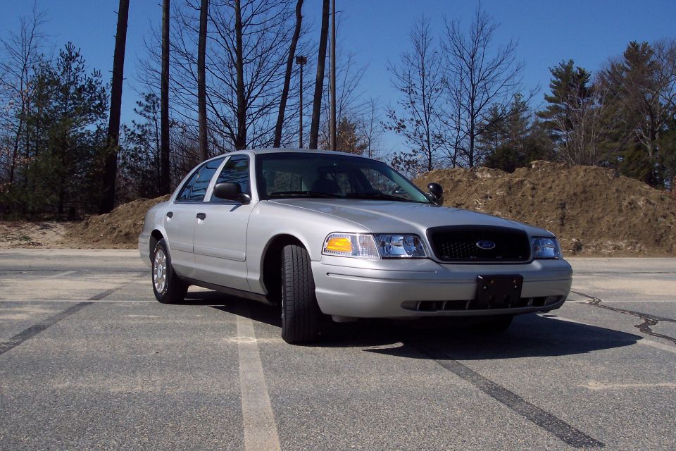 Silver 2001 Ford Crown Victoria sedan parked on asphalt lot