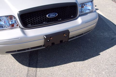 2001 Ford Crown Victoria - Front view of a silver 2003 Ford Crown Victoria, showing its grille and headlights.