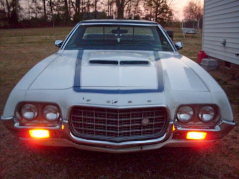 1972 Ford Ranchero - Front view of a white 1972 Ford Ranchero, blue racing stripes on the hood and distinctive grille.