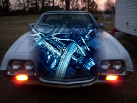 1972 Ford Ranchero - A 1972 Ford Ranchero is shown from the front, with a digital overlay of its engine components.
