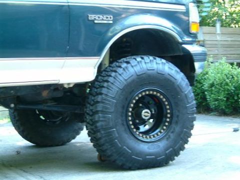 1993 Ford Bronco - Close-up of a 1993 Ford Bronco's side, focusing on the massive off-road tire and fender.