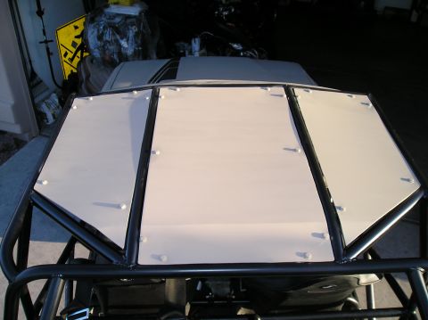 1986 Toyota Hilux - A custom roll cage is installed over the hood of a vehicle with racing stripes.