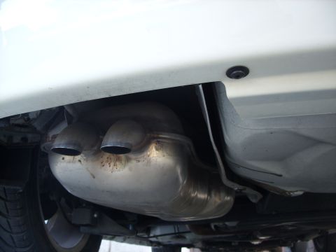 2003 Volkswagen Beetle - Underside view of a vehicle's exhaust system, dual tailpipes and the muffler.