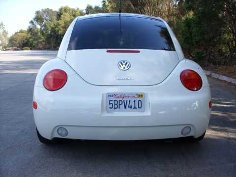 2003 Volkswagen Beetle - Rear view of a white 2003 Volkswagen Beetle showing its taillights, license plate, and turbo badge.