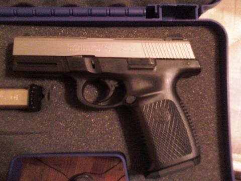 1987 Ford Crown Victoria LTD - A semi-automatic pistol and its magazine are displayed inside a protective case.
