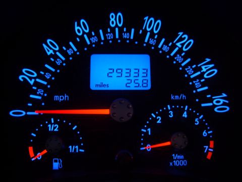 2003 Volkswagen Beetle - The illuminated dashboard displays the vehicle's speed, engine RPM, fuel level, and total mileage.