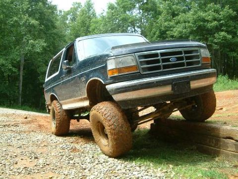 1993 Ford Bronco - Ford Bronco navigates an off-road obstacle course with its suspension flexed.