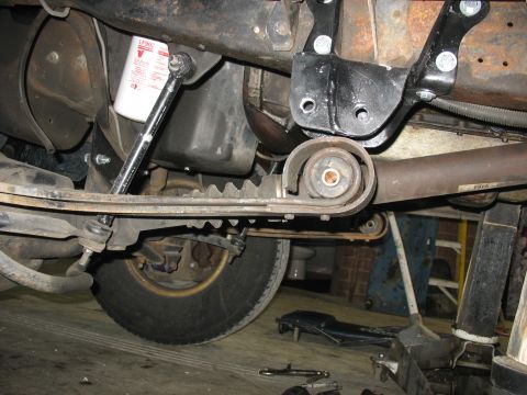 1995 Ford C-350 (Centurion Conversions) - Close-up of the truck's undercarriage, showing the leaf springs and steering linkage.