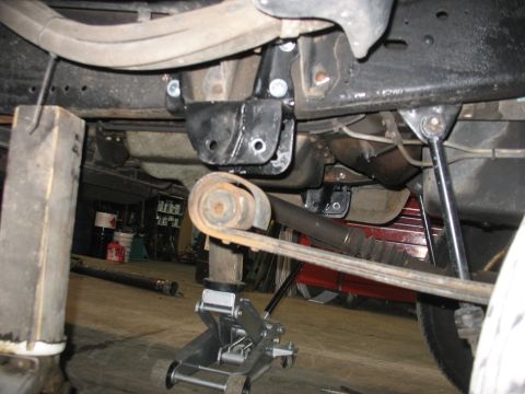 1995 Ford C-350 (Centurion Conversions) - Close-up view of the undercarriage, focusing on suspension parts and hardware.