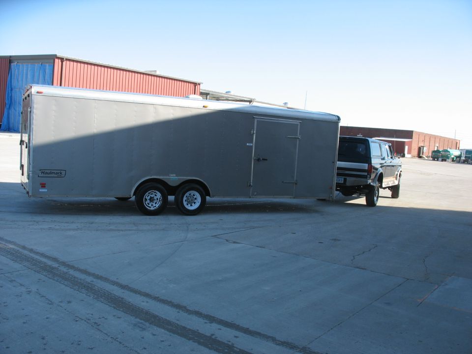 1992 Ford Bronco towing a silver Haulmark trailer