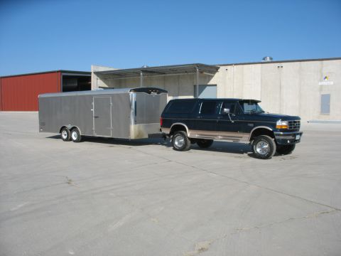 1995 Ford C-350 (Centurion Conversions) - This 1995 Ford C-350 Centurion Conversions SUV is shown from a three-quarter front view while towing a large silver trailer.