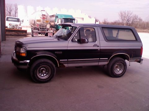 1995 Ford C-350 (Centurion Conversions) - Side profile of a 1995 Ford Bronco with two-tone paint. The vehicle is parked outdoors.