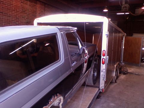 1995 Ford C-350 (Centurion Conversions) - A Ford Bronco is being backed into a trailer, with its front end visible.