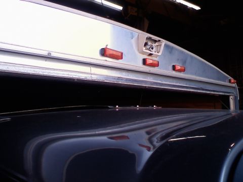1995 Ford C-350 (Centurion Conversions) - Close-up of a trailer's rear section, showing amber marker lights and a housing for a camera.