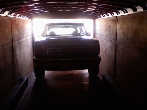 1995 Ford C-350 (Centurion Conversions) - Front view of a 1995 Ford C-350 (Centurion Conversions) parked inside a trailer.
