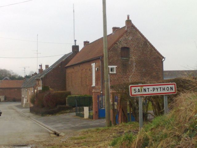 Brick farmhouses at the Saint-Python village entrance sign