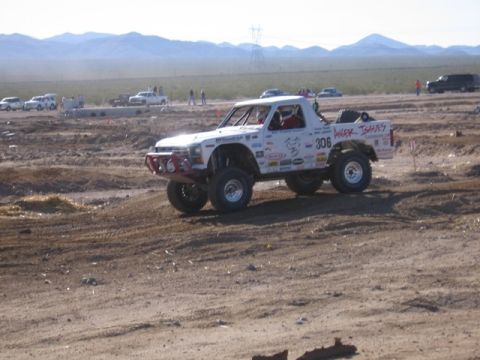 1986 Ford Bronco - This modified truck is equipped for off-road racing, with a roll cage and large tires.