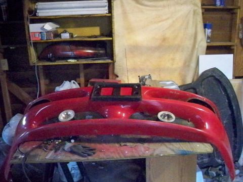 1995 Ford Probe - Front bumper assembly for a car, possibly a Ford Probe, shown in a workshop.