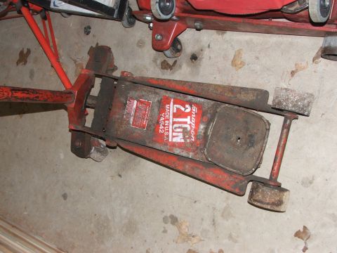 1965 Ford Mustang - A red Snap-on 2 ton floor jack is shown on a concrete floor.
