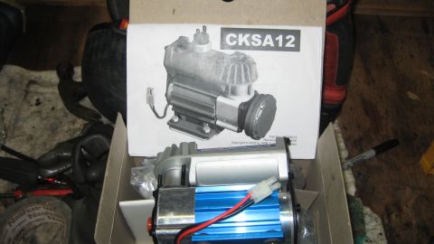 1978 Ford Bronco - An air compressor is shown in its box, with a diagram of the unit on the packaging.