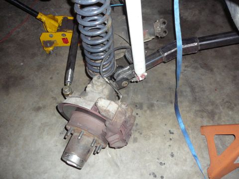 1991 Ford Bronco - Close-up view of a vehicle's suspension system, including a coil spring and shock absorber.
