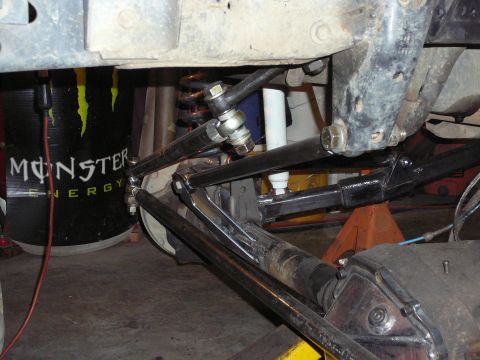 1991 Ford Bronco - Custom suspension components are visible, with a Monster Energy drum in the background.