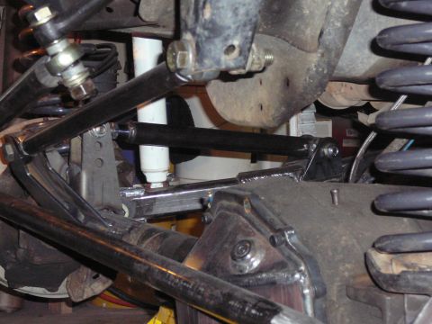 1991 Ford Bronco - Detailed view of aftermarket suspension parts, including shocks and linkages, likely for an off-road vehicle modification.