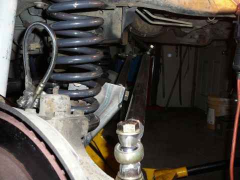 1991 Ford Bronco - Close-up view of vehicle suspension components, including a coil spring and brake rotor.