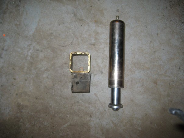 Shock absorber and square hitch receiver part on concrete floor