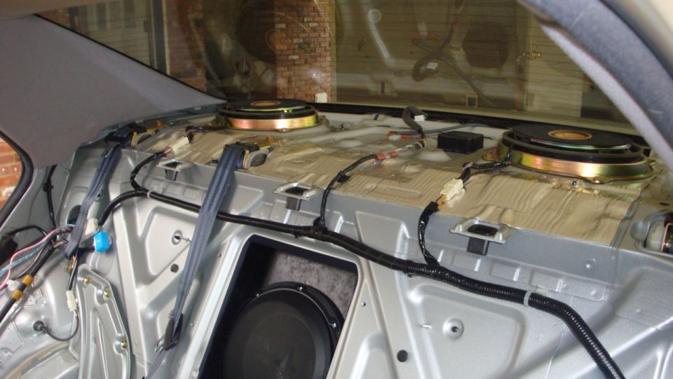 Stripped rear bulkhead with two speakers, sound deadener, wiring and lower woofer