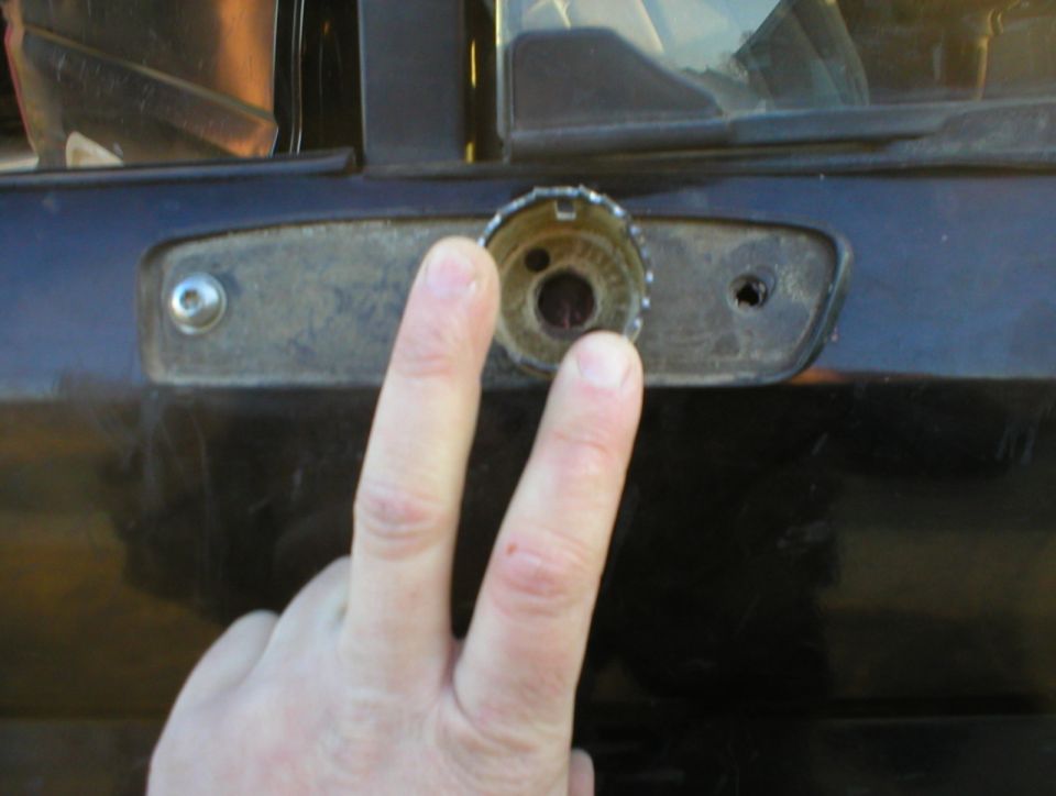 With the gasket held by the rear screw and the original nut plate, set a hole saw over the support arm hole so it totally covers it, but doesn't hang over the gasket, then mark & punch the center.  I think this is a 1 1/2" hole saw, but I'm not sure.
