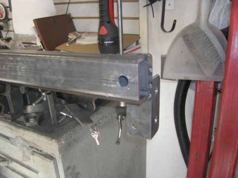 1996 Ford Bronco - Metal part, possibly a bumper section, with a hole drilled and a clamp attached. Keys are visible.