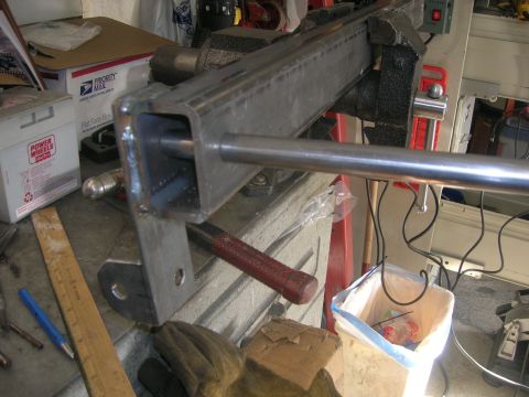 1996 Ford Bronco - A metal bar is secured in a vise, with tools and workshop items visible in the background.