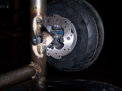 1991 Ford Bronco - Close-up of a custom welded frame with a tire and brake assembly.