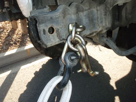1995 Ford Bronco - A vehicle's frame is shown with a tow hitch and recovery strap connected, ready for towing.