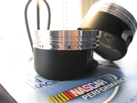 1994 Ford Probe - Close-up of engine pistons resting on a box NASCAR Performance branding.