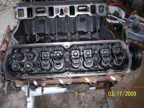 1990 Ford Bronco - Close-up of an engine block's valve train, with spark plugs visible.