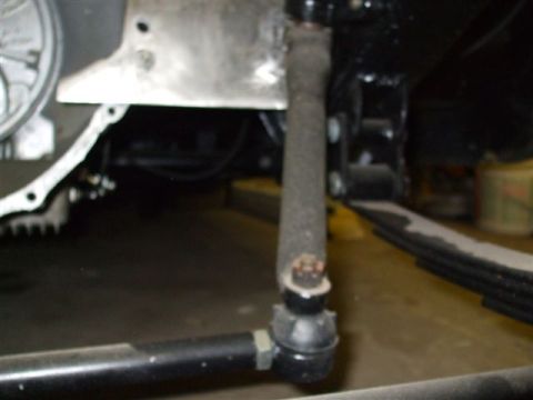 1963 Ford Galaxie - Close-up view of steering and suspension components, including a pitman arm and tie rod end.