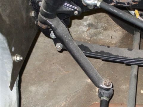 1963 Ford Galaxie - Close-up view of a vehicle's pitman arm and leaf spring assembly, likely from the steering or suspension system.